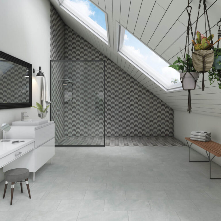 loft bathroom with grey tile floor and chevron patterned shower