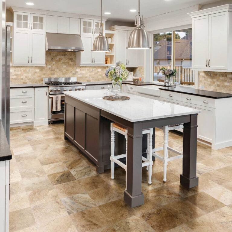 European style kitchen with large island and rustic brown tile floor