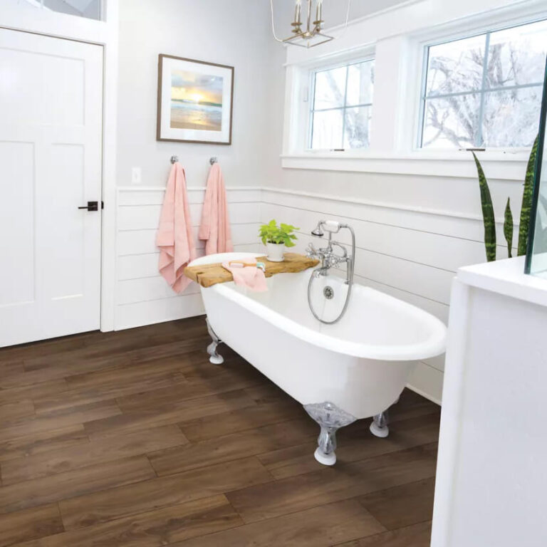 light brown vinyl flooring used in a a bathroom with a free standing soaker tub