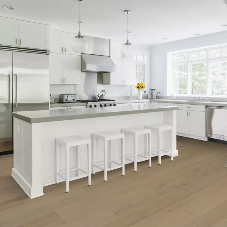 White on white kitchen with luxury stone counters and light colored laminate flooring