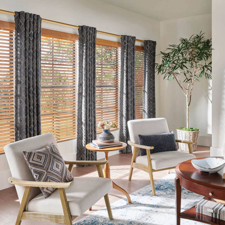 Wood blinds on tall windows with custom drapery at each end