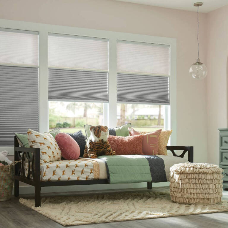 Graber combo shades in light grey on windows in a living room