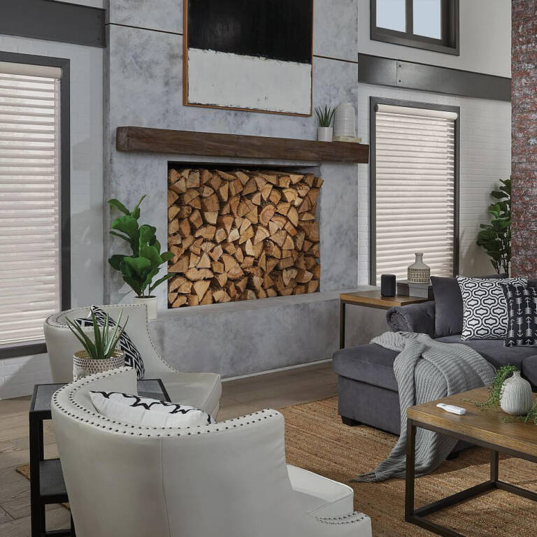 sheer shades covering windows flanking a fireplace