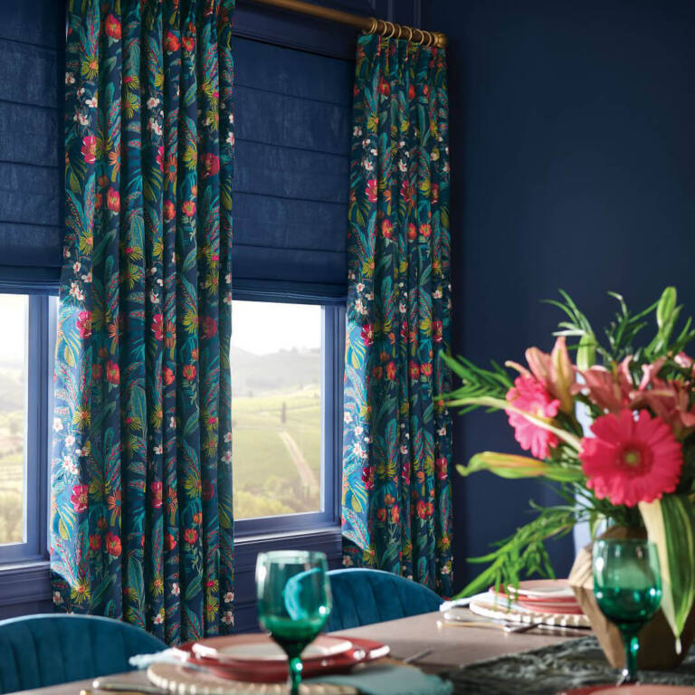 elegant floral ldrapery fabric in a dining room with dark blue walls