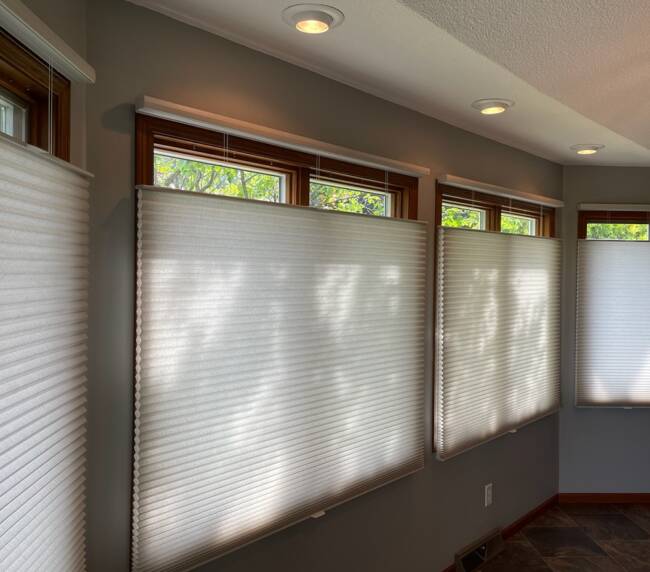 Sunroom with large windows featuring honeycomb shades, recessed lighting, and a tiled floor