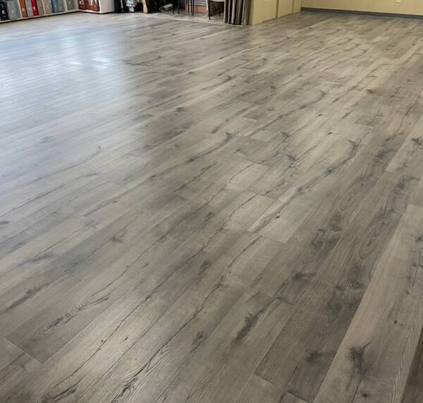 Spacious room with gray wood-look flooring