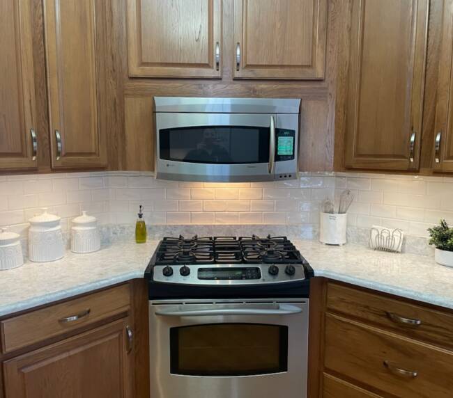 kitchen featuring wooden cabinets, stainless steel appliances, and a subway tile backsplash