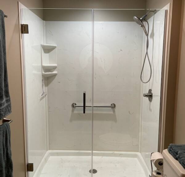 shower with sleek white tiles and a glass enclosure