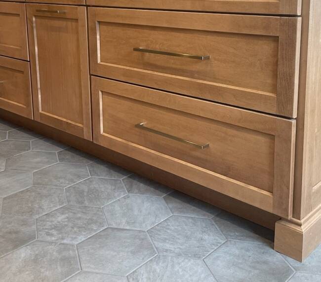 Hexagonal gray tile flooring in a kitchen with a wooden island